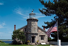 American Flag Waves In Front of Stonington Harbor Lighthouse Mus